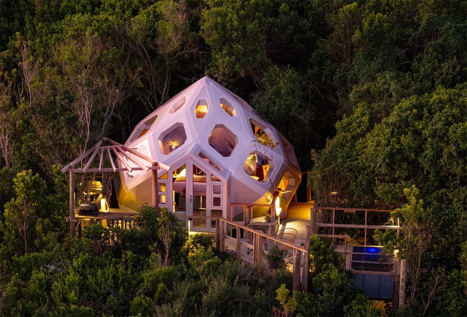 A lit GeoMod dome at dusk, seen from the air