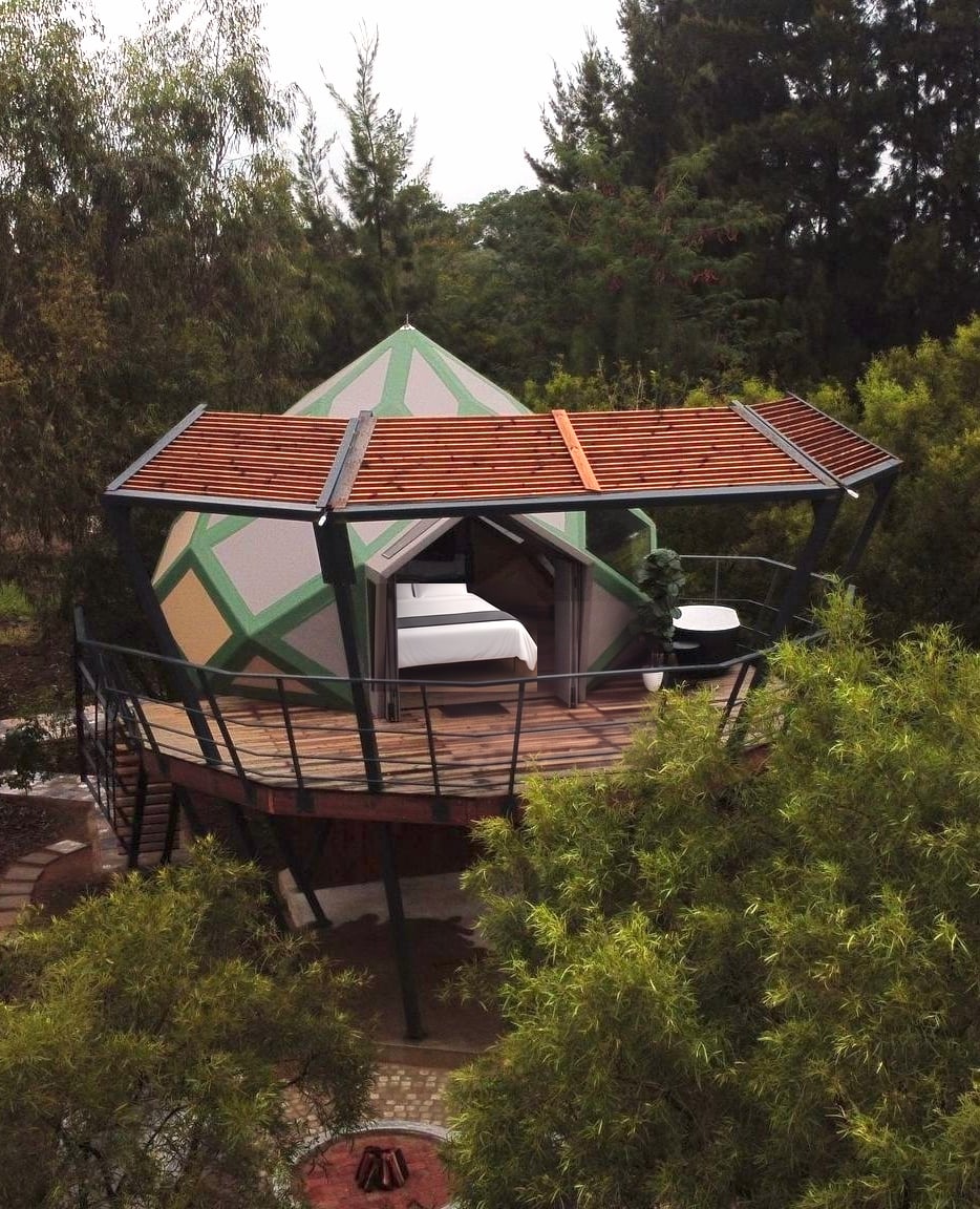 Dome under a timber pergola on a raised deck among tall trees at Rosemary Hill